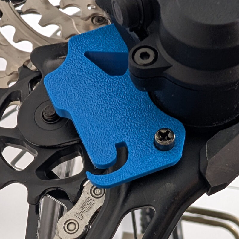 Derailleur J Lock Tool installed on a mountain bike rear derailleur, holding the cage retracted during maintenance
