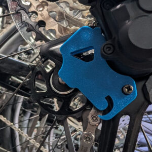 Blue Derailleur J Lock Tool installed on a Shimano-style mountain bike rear derailleur during wheel service